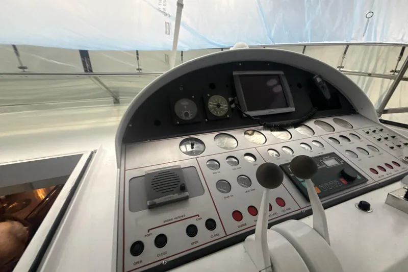 Slide: The Image of Control panel of a 1999 Diaship 53 yacht with gauges and levers. - 27