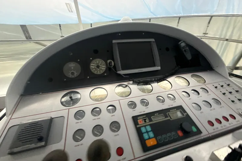 Slide: The Image of Control panel of a 1999 Diaship 53 boat with gauges and a monitor. - 28