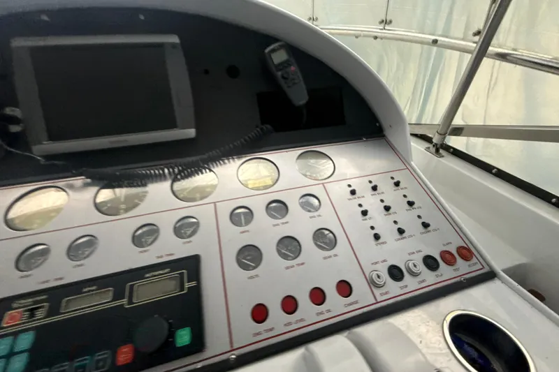 Slide: The Image of Control panel of a 1999 Diaship 53 boat with gauges and switches. - 29