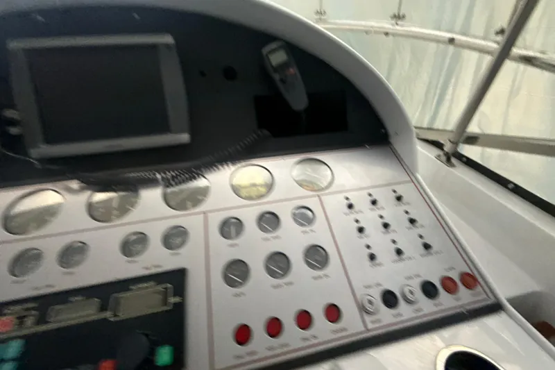 Slide: The Image of Control panel of a 1999 Diaship 53 boat with gauges and switches. - 30