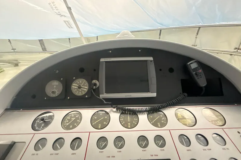 Slide: The Image of Cockpit dashboard of a 1999 Diaship 53 with gauges and navigation equipment. - 31