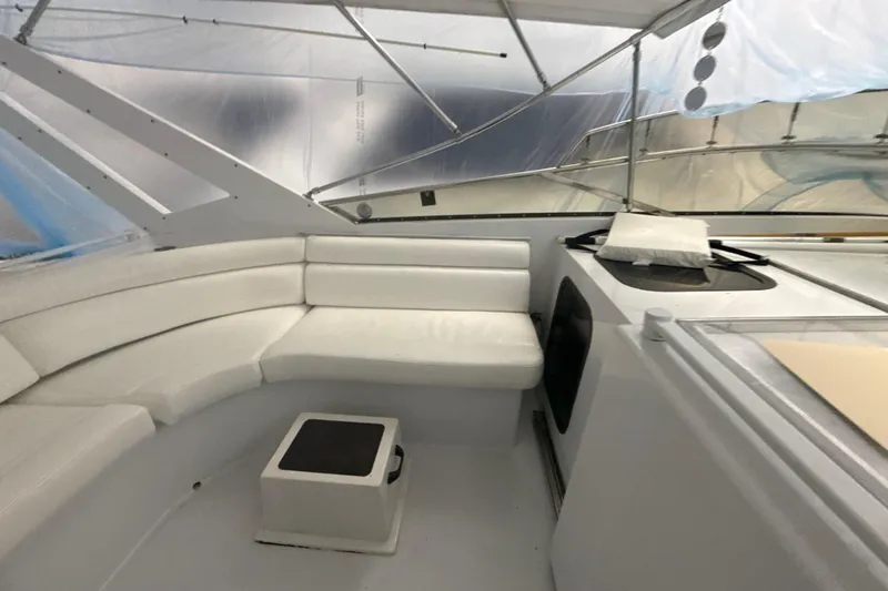 Slide: The Image of Interior of a 1999 Diaship 53 yacht with white seating and modern design. - 38