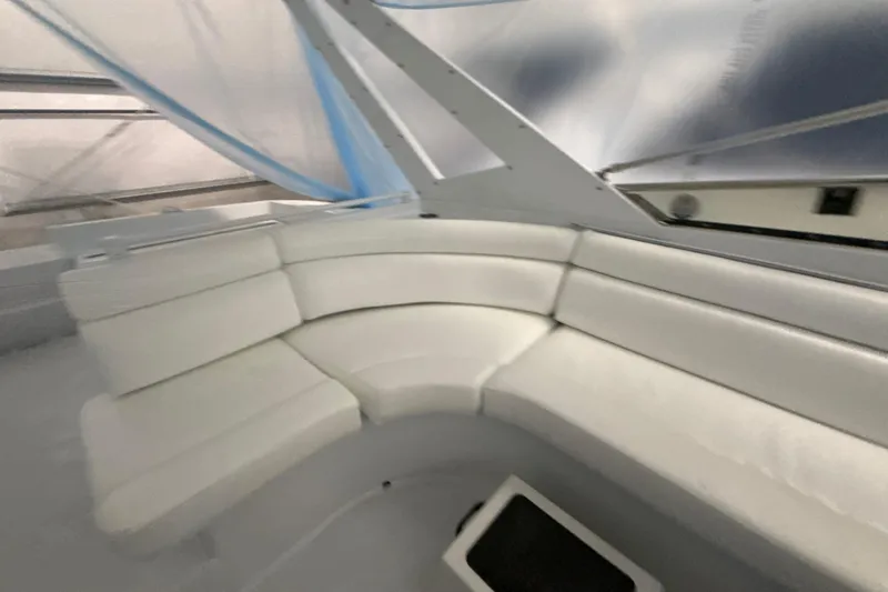 Slide: The Image of Interior of a 1999 Diaship 53 yacht with white curved seating. - 39