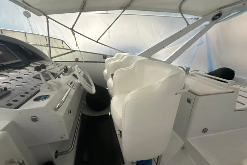 Slide: The Image of Interior of a 1999 Diaship 53 yacht cockpit with white seating and control panel. - 40