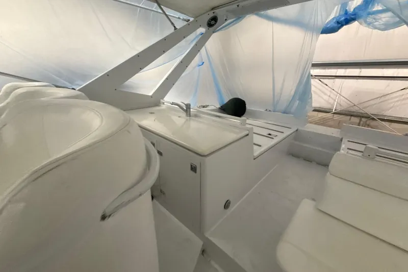 Slide: The Image of Interior of a 1999 Diaship 53 yacht, featuring white seating and cabinetry. - 41