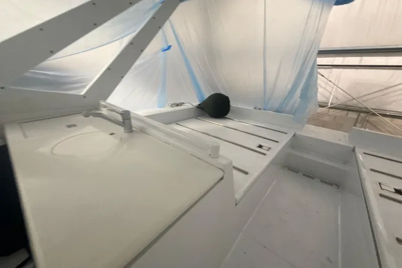 Slide: The Image of Interior of a 1999 Diaship 53 yacht with white surfaces and blue tarp. - 42
