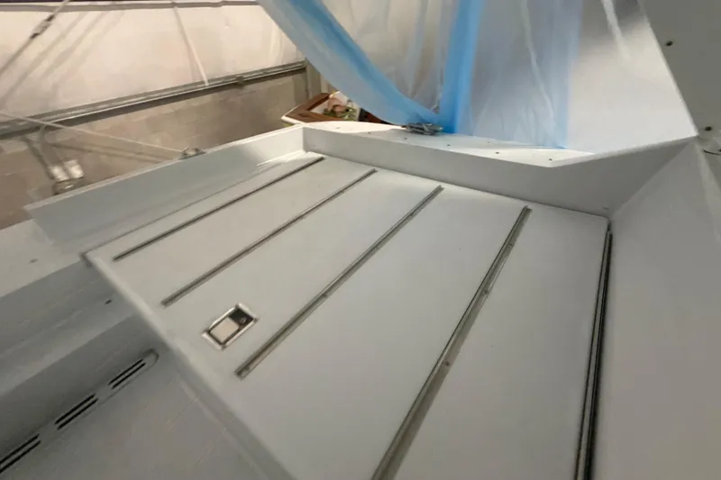 Slide: The Image of White deck of a 1999 Diaship 53 yacht with metal rails and hatch. - 43