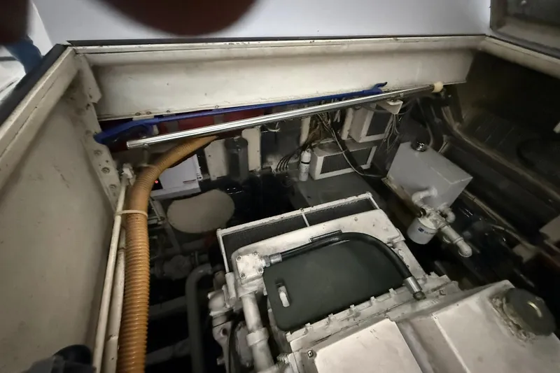 Slide: The Image of Engine room of a 1999 Diaship 53, showcasing mechanical components and wiring. - 46