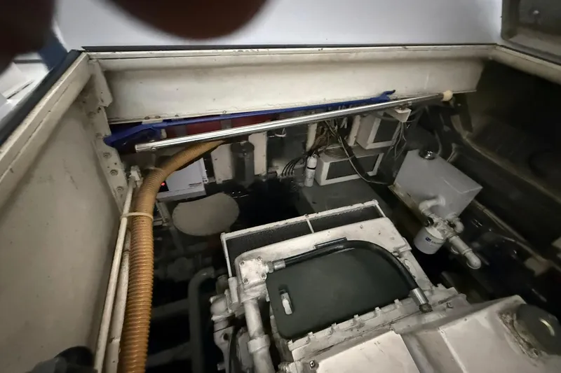 Slide: The Image of Engine compartment of a 1999 Diaship 53 boat, showing mechanical components and wiring. - 47