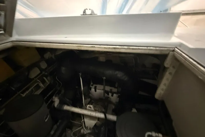 Slide: The Image of Engine compartment of a 1999 Diaship 53 boat, showcasing mechanical components. - 48
