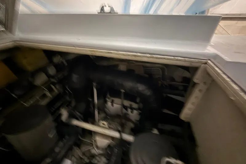 Slide: The Image of Engine compartment of a 1999 Diaship 53, showcasing mechanical components and piping. - 49