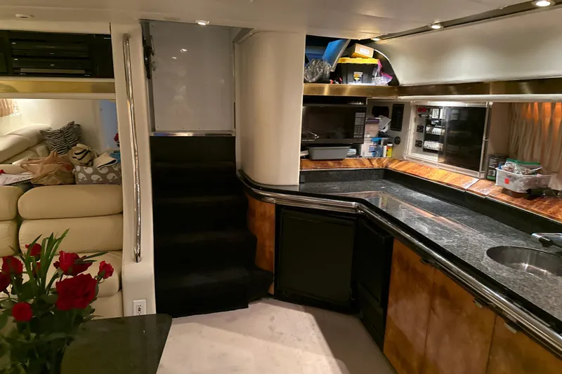 Slide: The Image of Luxurious 1999 Diaship 53 yacht interior with modern kitchen and cozy seating area. - 5