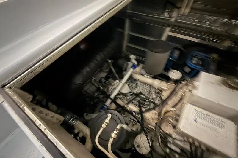 Slide: The Image of Engine compartment of a 1999 Diaship 53, showcasing mechanical components and wiring. - 51