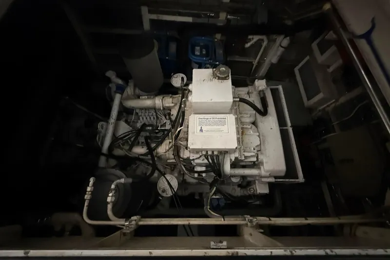 Slide: The Image of Engine room of a 1999 Diaship 53, featuring complex machinery and piping. - 52