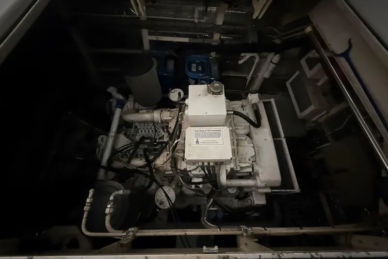 Slide: The Image of Engine room featuring a 1999 Diaship 53 model engine with visible pipes and components. - 53