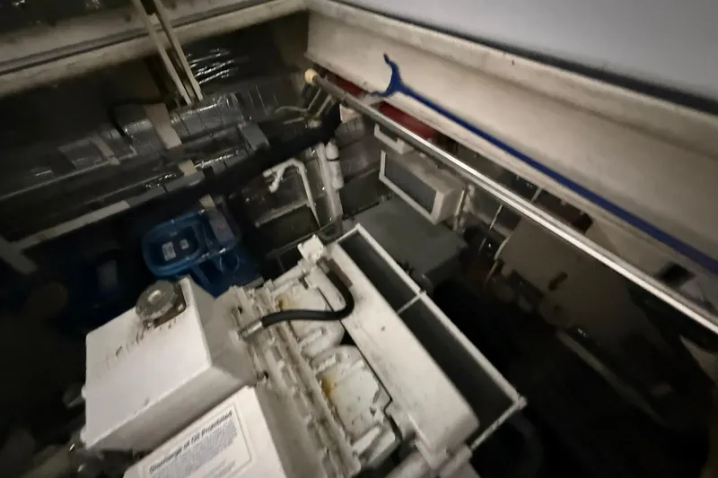Slide: The Image of Engine room of a 1999 Diaship 53 yacht, featuring machinery and equipment. - 55
