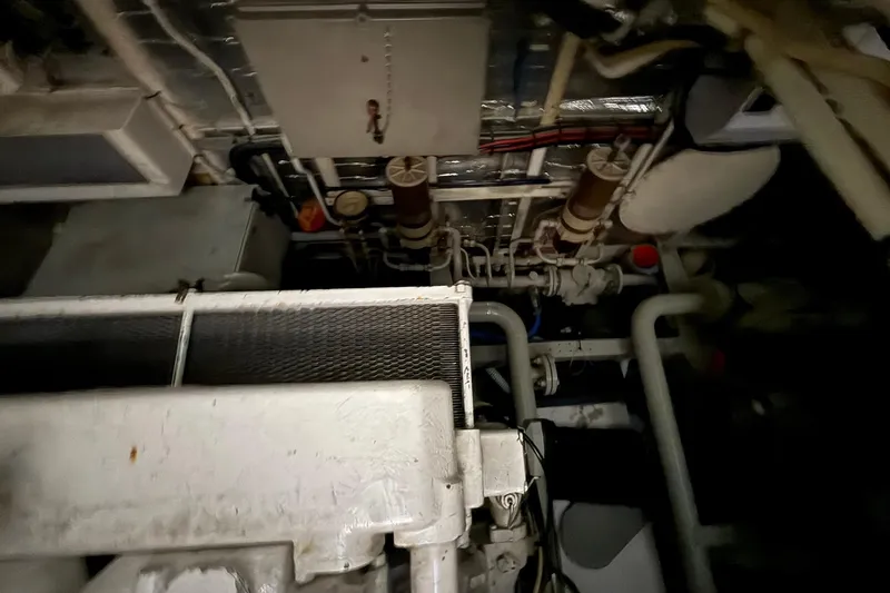 Slide: The Image of Engine room of a 1999 Diaship 53, featuring complex piping and machinery. - 56