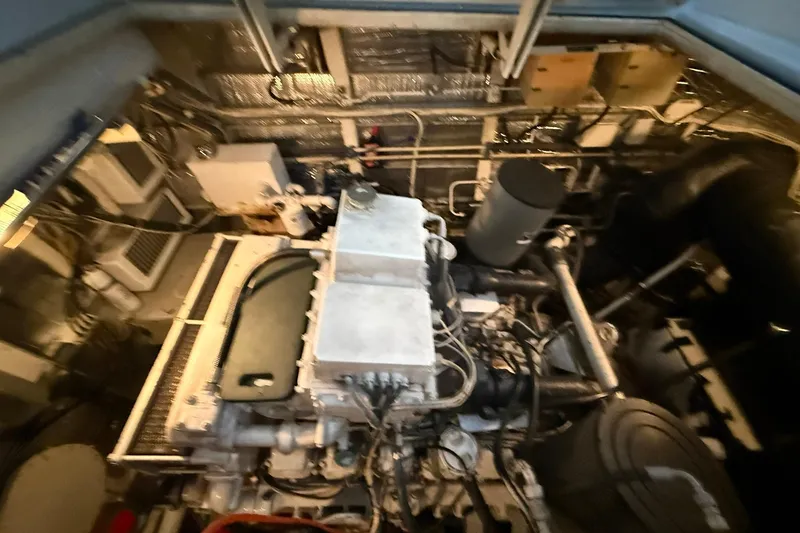 Slide: The Image of Engine room of a 1999 Diaship 53, showcasing mechanical components and wiring. - 59