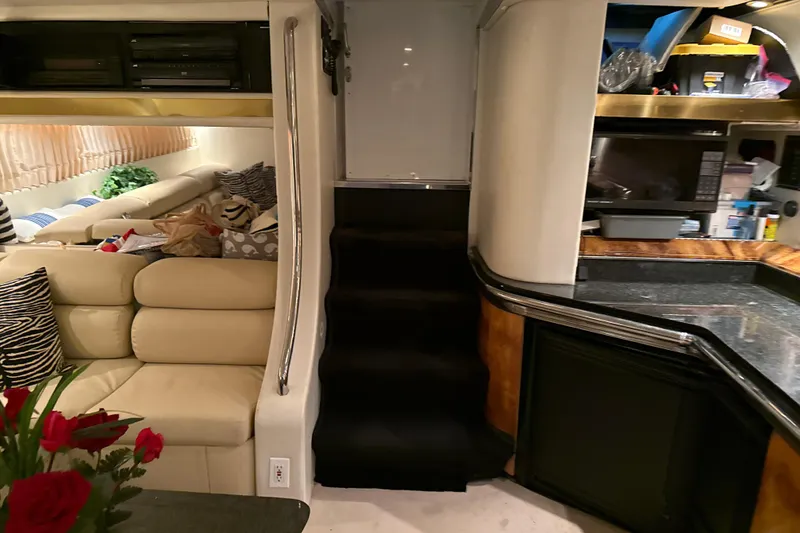 Slide: The Image of Interior of a 1999 Diaship 53 yacht with beige seating and modern kitchen. - 6
