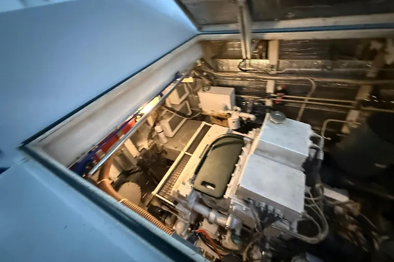 Slide: The Image of Engine room of a 1999 Diaship 53 yacht, showcasing machinery and components. - 60