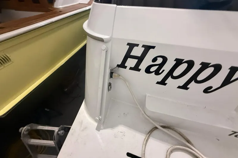 Slide: The Image of Rear view of a 1999 Diaship 53 boat with "Happy" text. - 63