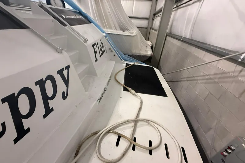 Slide: The Image of 1999 Diaship 53 boat in storage, featuring "Happy Fish" text, Toledo, Ohio. - 64