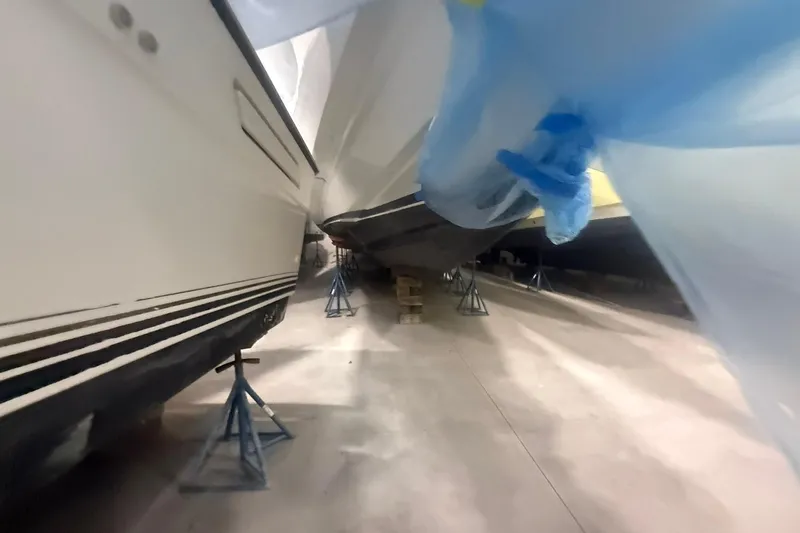 Slide: The Image of Boats in storage, supported by stands, with protective covers, Diaship 53, 1999 model. - 67