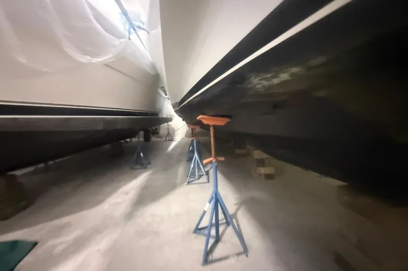 Slide: The Image of Two Diaship 53 yachts from 1999 in dry dock, supported by stands. - 69