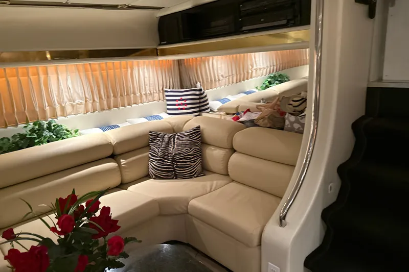 Slide: The Image of Luxurious 1999 Diaship 53 yacht interior with beige leather seating and decorative pillows. - 7