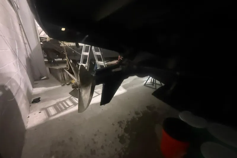 Slide: The Image of Boat propeller and rudder in a dimly lit garage, Diaship 53, 1999 model. - 73