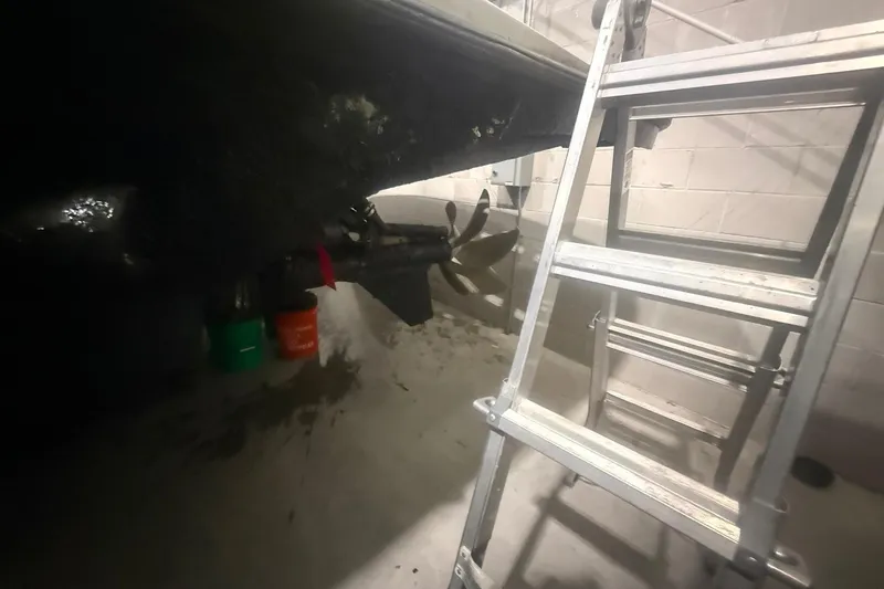 Slide: The Image of Ladder beside Diaship 53 boat propeller in a garage, 1999 model. - 77