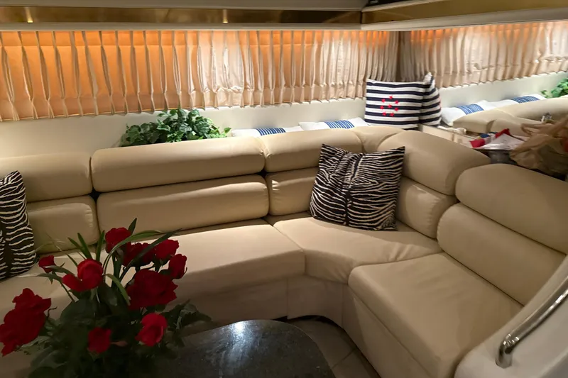 Slide: The Image of Luxurious Diaship 53 yacht interior with beige leather seating, zebra pillows, and red roses, 1999 model. - 8