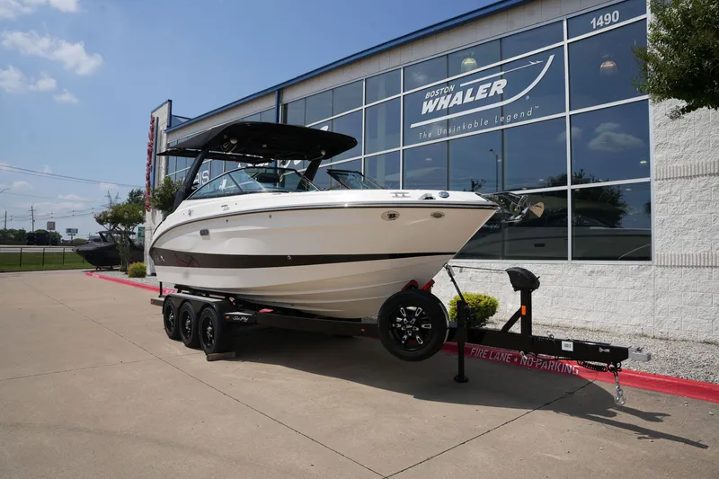 Slide: The Image of 2025 Sea Ray SLX 260 Surf boat in front of Boston Whaler building. - 1