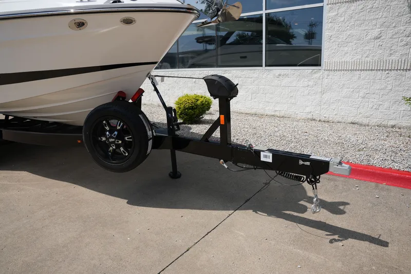 Slide: The Image of 2025 Sea Ray SLX 260 Surf boat on trailer, close-up view. - 4