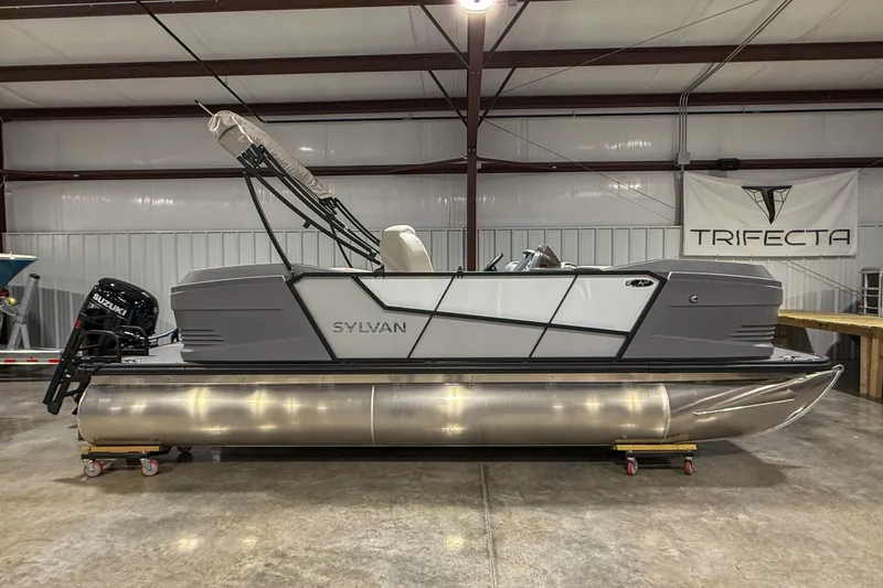 The Image of 2026 Sylvan A20 pontoon boat in a warehouse, featuring sleek design and Suzuki motor. - 1