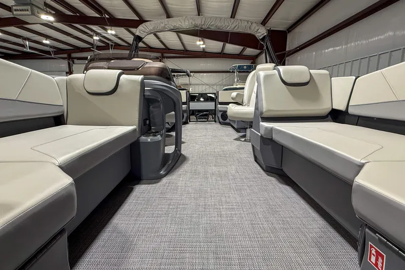 Slide: The Image of 2026 Sylvan A20 boat interior with spacious seating in a warehouse setting. - 4