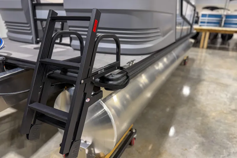Slide: The Image of 2026 Sylvan A20 pontoon boat with a black boarding ladder on display. - 8