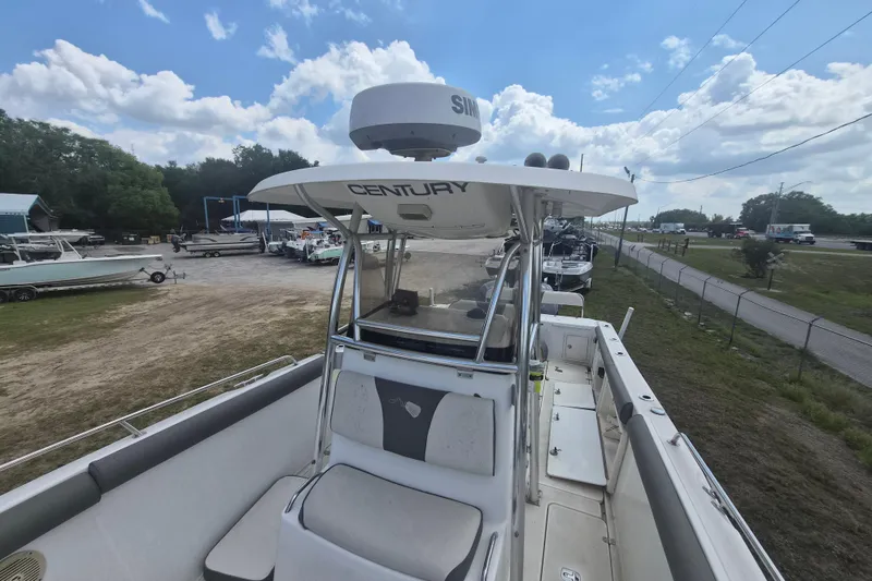 Slide: The Image of 2006 Century 2900 Center Console boat at a marina under a partly cloudy sky. - 16