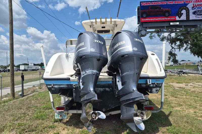 Slide: The Image of 2006 Century 2900 Center Console boat with dual Yamaha 300 engines, parked outdoors. - 2