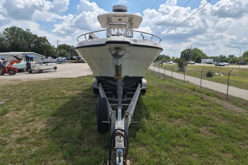 Slide: The Image of 2006 Century 2900 Center Console boat on trailer, parked on grassy area under cloudy sky. - 3