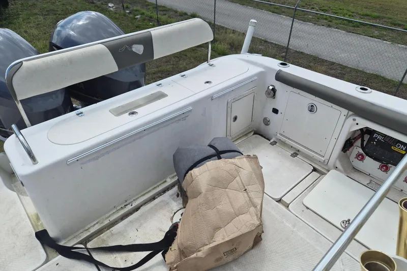 Slide: The Image of 2006 Century 2900 Center Console boat interior with storage compartments and dual engines. - 4