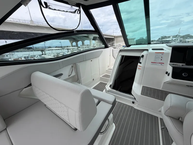 Slide: The Image of The image shows the cockpit of a Sea Ray Sundancer 320 Outboard with modern seating and an open roof. - 21