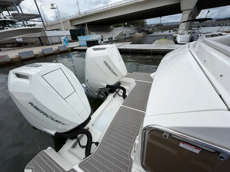 Slide: The Image of The image shows two Mercury outboard engines on a Sea Ray Sundancer 320 boat docked at a marina. - 20