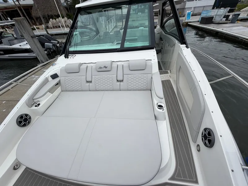 Slide: The Image of The image shows the cockpit of a 2027 Sea Ray Sundancer 320 Outboard with white upholstery. - 24