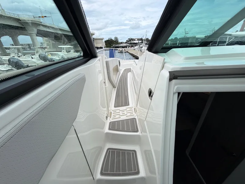 Slide: The Image of The image shows the narrow walkway of a Sea Ray Sundancer 320 Outboard with gray steps. - 22
