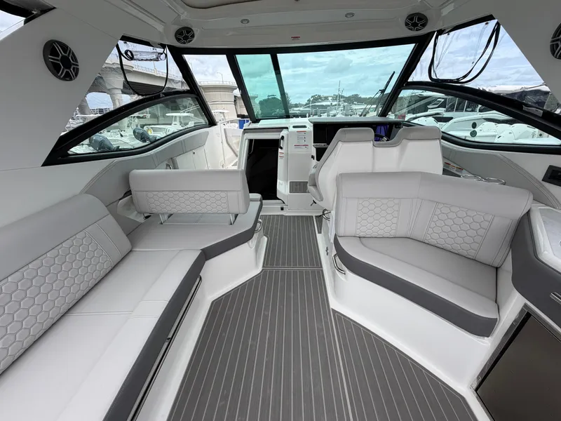 Slide: The Image of Interior of a modern yacht with gray and white upholstery, large windows, and stylish design. - 17