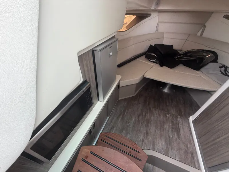 Slide: The Image of Interior of a Sea Ray Sundancer 320 Outboard with modern amenities and a cozy seating area. - 26