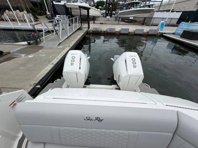 Slide: The Image of The image shows the stern of a Sea Ray Sundancer 320 Outboard with two large outboard engines. - 15