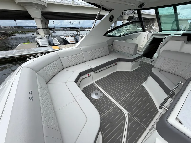 Slide: The Image of The image shows the cockpit of a Sea Ray Sundancer 320 Outboard with sleek gray upholstery. - 19