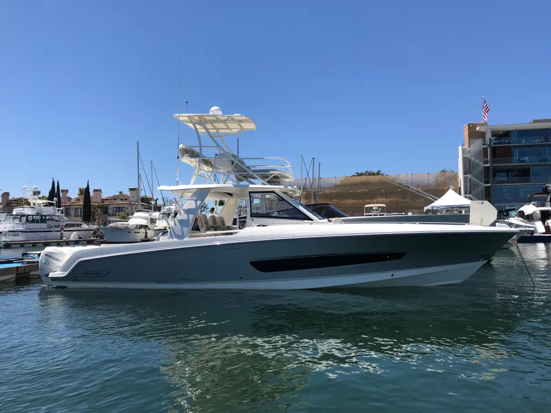 Slide: The Image of 2018 Boston Whaler 420 Outrage boat docked in a marina on a sunny day. - 3